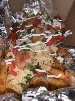 Bayou Fries includes shrimp, spicy creamy alfredo sauce, tomatoes, sour cream, and cilantro