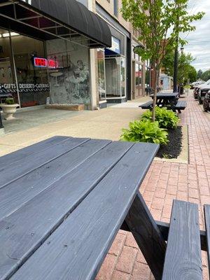 Picnic benches out front for sidewalk dining