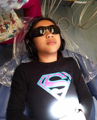 My little Supergirl's first visit. Enjoying the cool shades while watching the ceiling television.