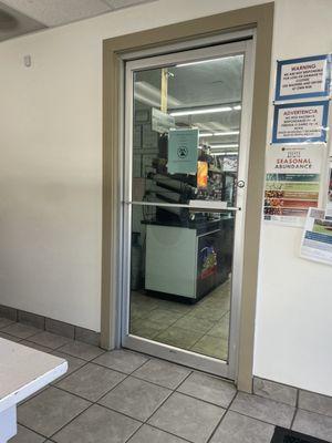 Door from laundromat to minimart from the inside