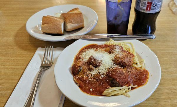 Spaghetti and meatballs, rolls and butter.