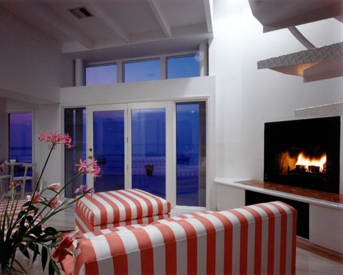 NEW LIVING ROOM WITH FIREPLACE AND WATER VIEW.