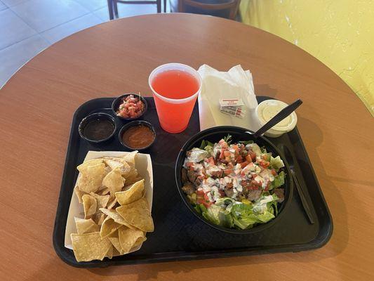 Salad bowl with grilled chicken, and pork carnitas. Every meal comes with chips and salsa!