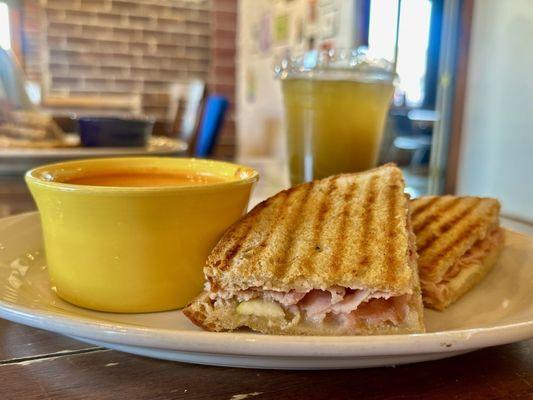 Ham, brie cheese, and apple panini (half sandwich) with a cup of tomato bisque.