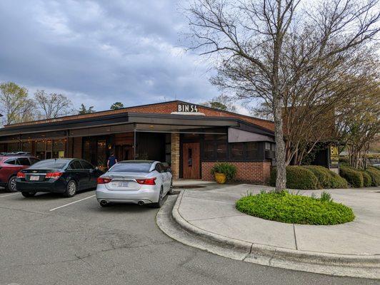 Exterior shot of Bin 54 Steak & Cellar, the steakhouse located at Glen-Lennox Shopping Center. I took this photo on March 28, 2023.