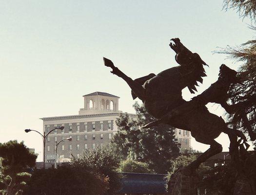 Only in Fresno can you see an ugly equine statue leaping over a venerably old hotel building.