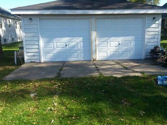 Took down 2  wood doors  & re framed  And installed 2 new steel c.h.i overhead doors