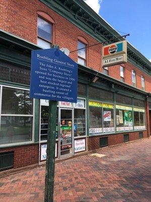 Historical marker in front of store.