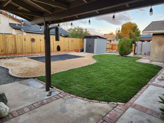 New sod, mow curbing, stamped concrete patio pad, California Gold rock.