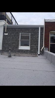 ( After ) New roof , including new architectural shingles , App-180 white ( flat roof ) , new gutter / downspout , and window frame cover .