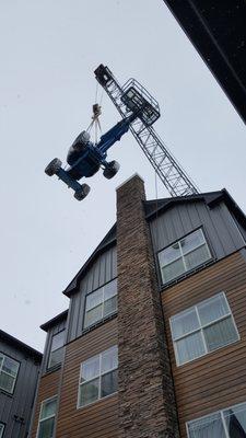 To Replace the Siding on the Hotel We had to Lift a Articulated Boom Lift Up and Over the Hotel to Remove and Replace the Siding