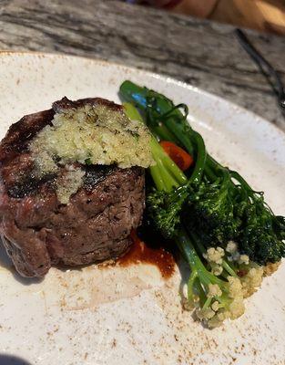 Filet Mignon topped with a blue cheese topping served with mashed potatoes and parmesan broccolini