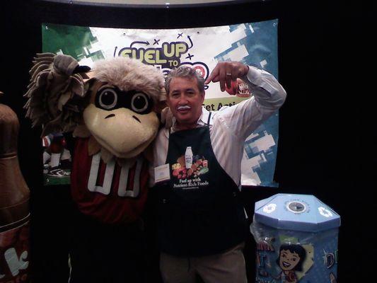 Angelo with Freddie the Falcon Fueling Up to Play 60 contest which he won with his milk mustache.