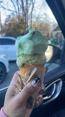 Pistachio and green tea ice cream on a pretzel cone