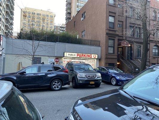 Cars in street and on sidewalk