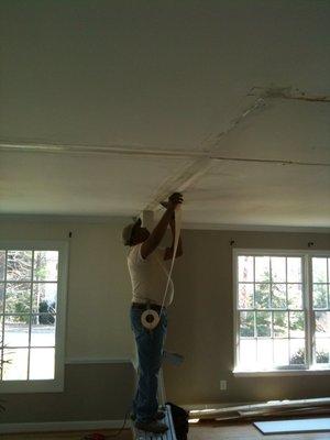 We removed some walls in a ranch to open it up and Charles is doing some drywall repairs