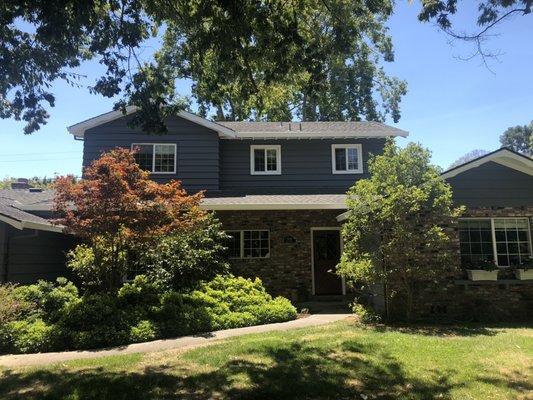 This house just received some TLC, painted with a dark gray body and white trim.