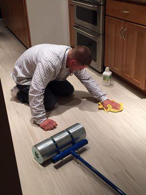 Jason hard at work in our kitchen, cleaning off the brand new Armstrong vinyl tiles.