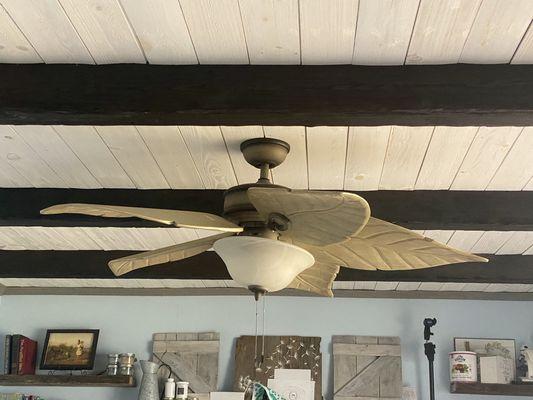 Covered popcorn ceiling with shiplap boards and custom beams.