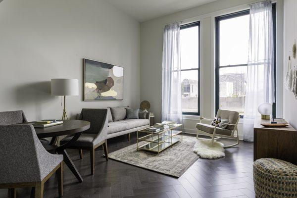 Herring bone flooring, neutral palette and over-sized windows.