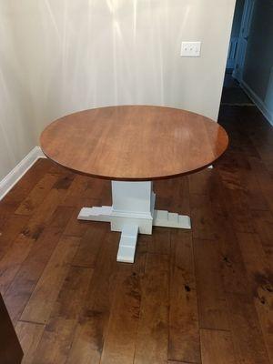 A custom built breakfast table with a cherry top and painted base.