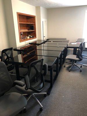 Office furniture assembly. Adjustable height desk and office chairs