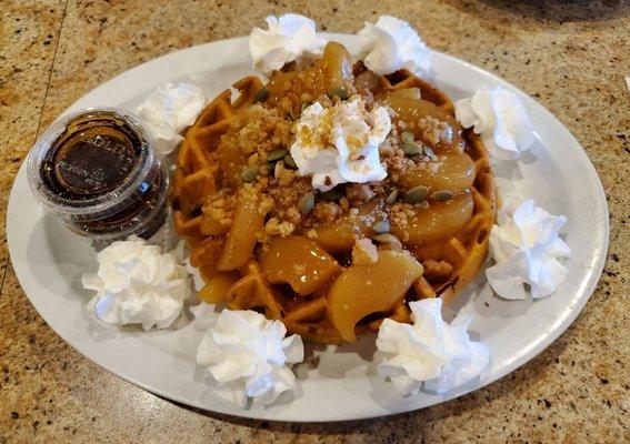 Pumpkin waffle with Dutch apple topping, crumble, pumpkin seeds and whipped cream. Syrup included but not needed!