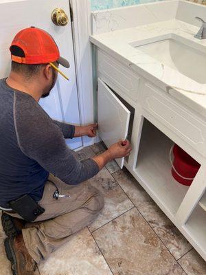 Painted Cabinets, Installed New Tile Flooring, and Installed New Countertop and Sinks in Bathroom Remodel