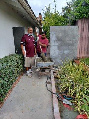 Richard and Oscar stirring some cement for the wall