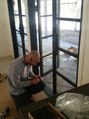 Will from Stice lock installing Emtek hardware on our iron doors