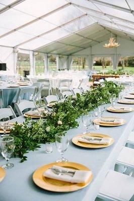 Banquet style table setting with gold charger rentals.