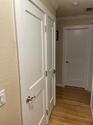 Hallway closets and bathroom door.