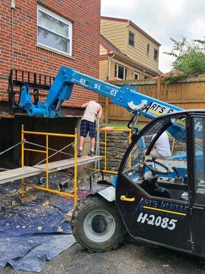 Removing old stucko and replacing steel lintel above garage door. Replacing block and brick then re appling the stucko