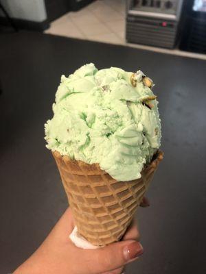 Pistachio ice cream on a waffle cone