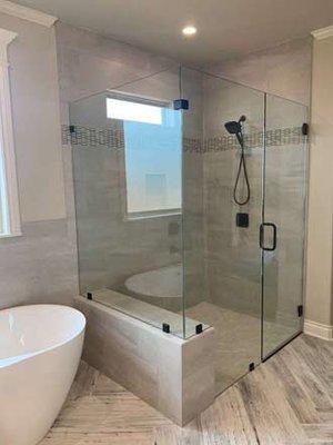 Frameless glass shower enclosure