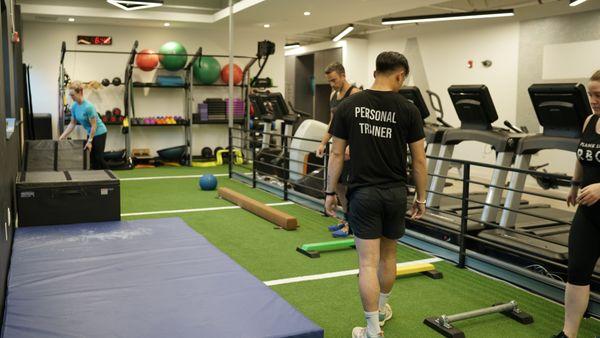 One of our personal trainers walking a client through an agility and balance drill.