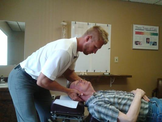 Dr. Mark Kraft adjusts a patient's neck.