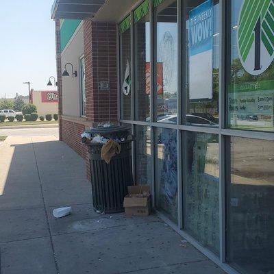 Overflowing trash cans by the entrance.