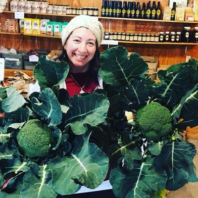 Jessica showing off some homegrown broccoli.