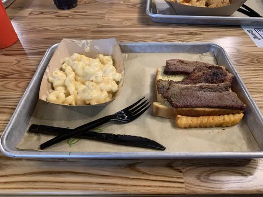 Brisket on bread with delicious Mac & cheese.