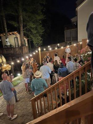 Beautiful birthday celebration.  The crowd listening to the guitarist.