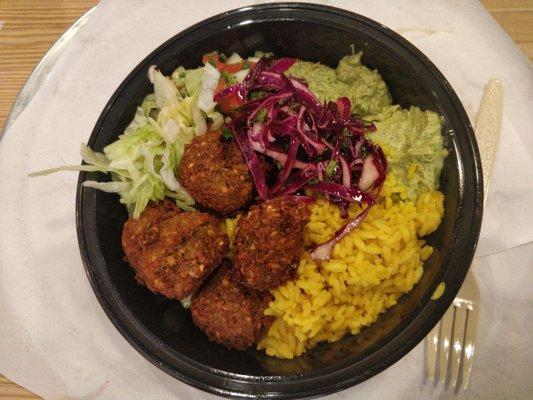 Falafel  Bowl with Yellow Rice, Cucumber Salad,  Spinach & Jalapeño hummus.