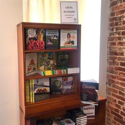 Shelf of vegan books by local authors