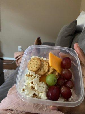 Mini crackers, cheese tray, grapes, olive oil popcorn --- my snack mixture!