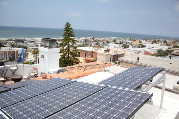 Solar system installation on a flat roof.  Hermosa Beach, CA