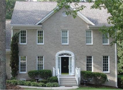 The front of the house looks spectacular and new with the lighter colored brick and white trim, sans shudders