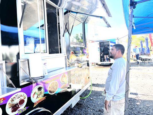 A man ordering food at the truck