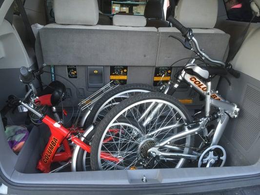 One Columba RJ26A folding bike and one Columba R20A folding bike in Trunk of a Toyota Sienna 2011.  Both bikes are folded.