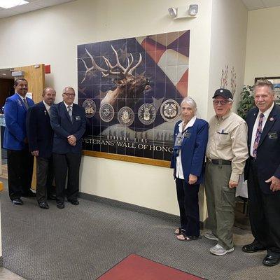 Members of the Veterans Committee in front of the Lodge's Veterans Wall of Honor.