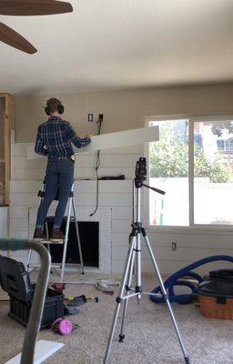 Shiplap wall, herringbone fireplace surround and custom built ins